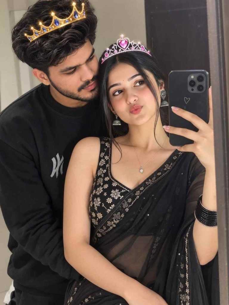 Romantic Indian couple taking a mirror selfie with black saree, black sweatshirt and digital crown filters